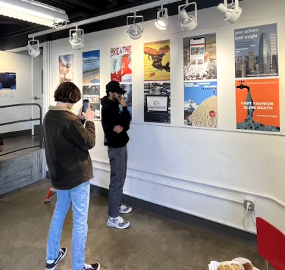 people in art gallery viewing posters